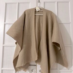 100% polyester shall. One size fits all. Tags attached. Thick and warm